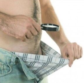 A man looks down his pants and wants to enlarge his penis with gel